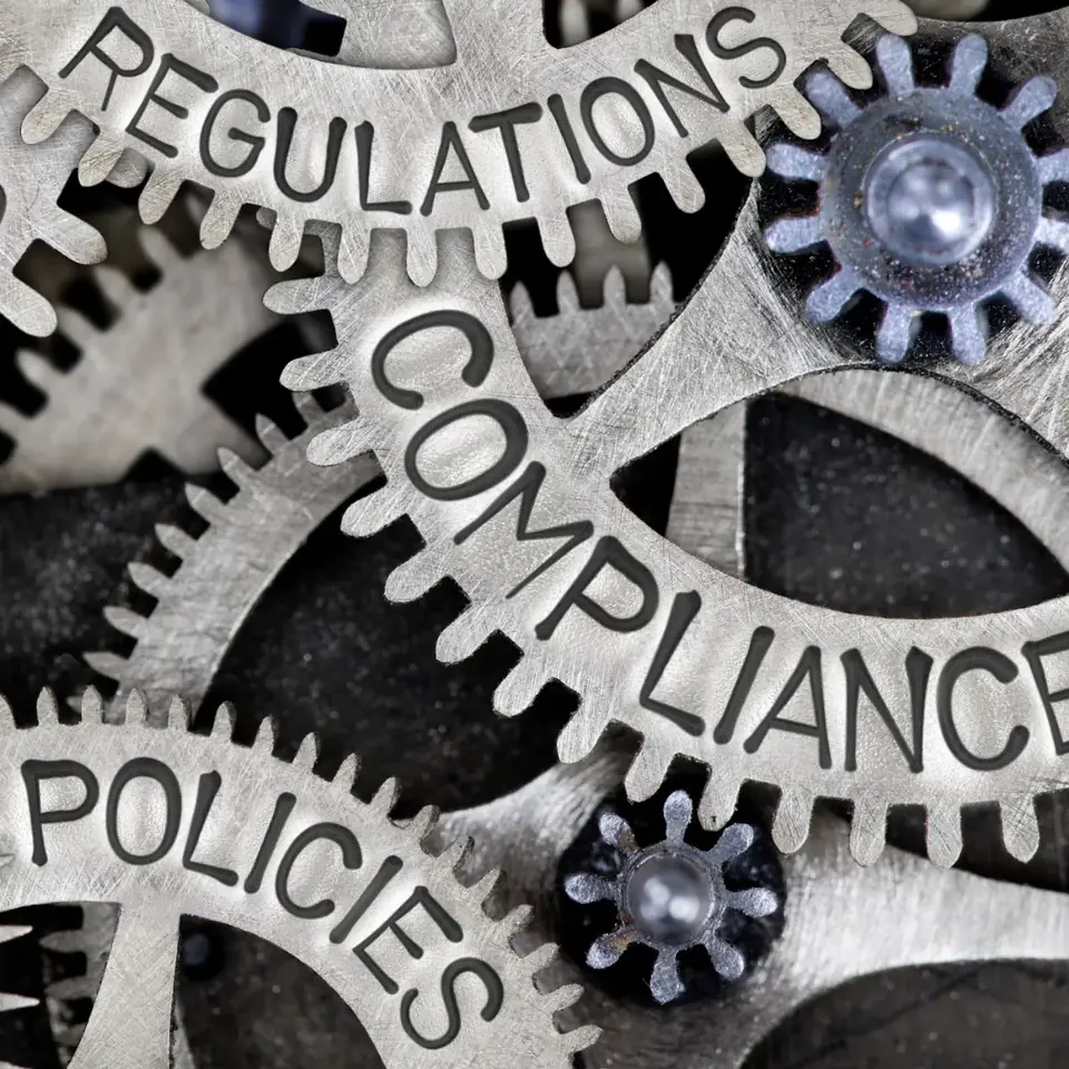 Gears labelled regulations, compliance and policies