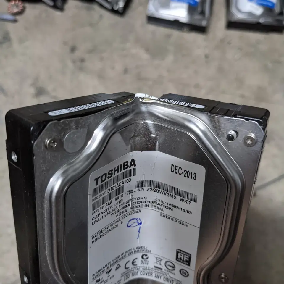 Hard disk drive bent in half by a crusher