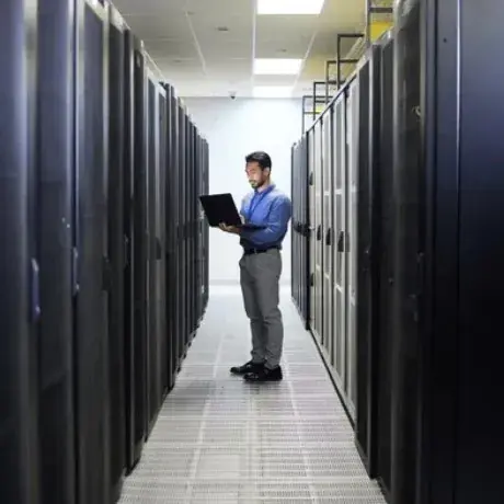 Technician working in a data centre aisle