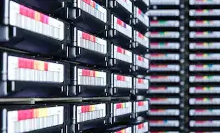 Tape library with rows of backup tapes